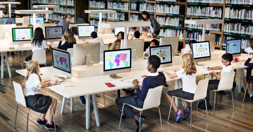 A vibrant classroom scene featuring students engaging with laptops and tablets, symbolizing the integration of AI tools like QuizSolver in modern education, enhancing learning and academic success.